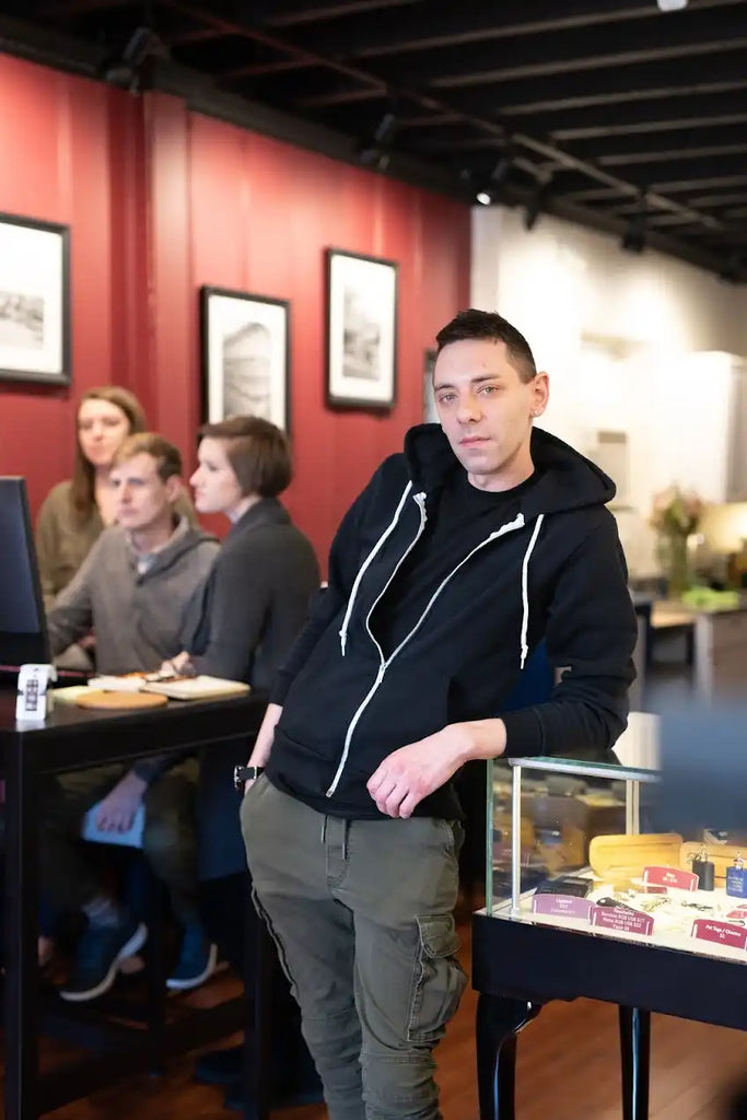 Man in black hoodie and cargo pants.